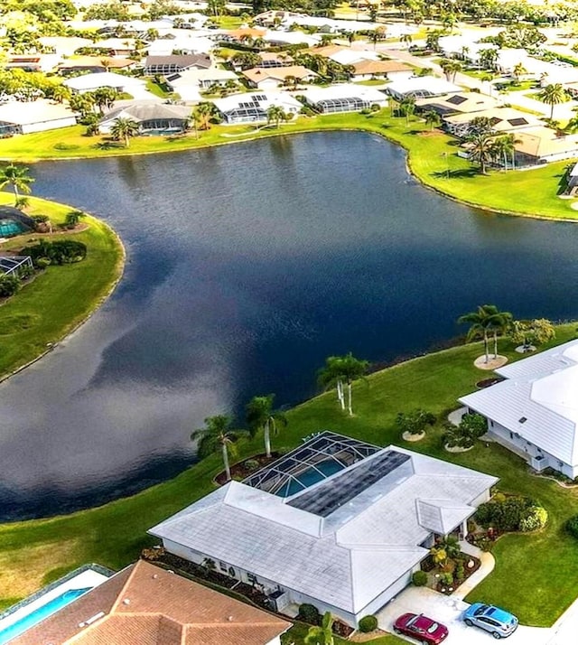 drone / aerial view with a water view and a residential view