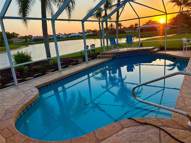 swimming pool with glass enclosure, a water view, a patio, and a lawn