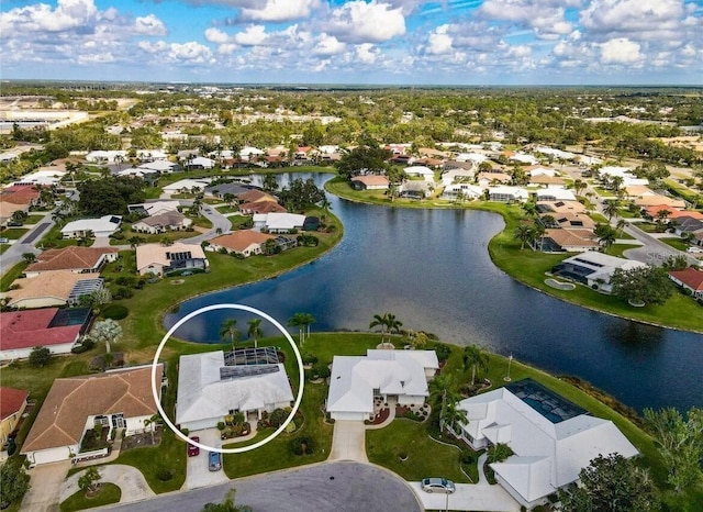 aerial view of residential area featuring a large body of water
