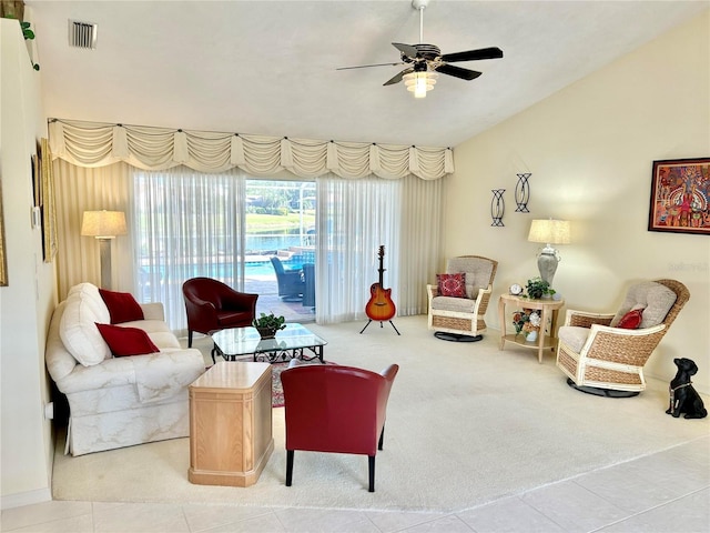 carpeted living area featuring ceiling fan and vaulted ceiling