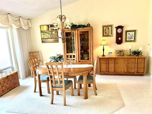 dining area featuring a chandelier and lofted ceiling