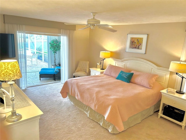 carpeted bedroom featuring access to exterior and a ceiling fan