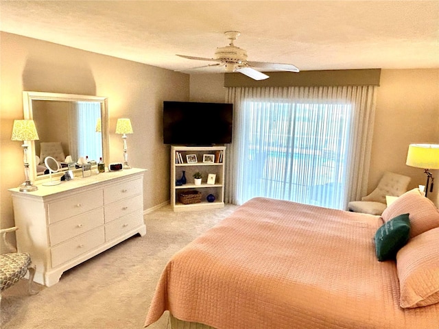 carpeted bedroom featuring ceiling fan and baseboards