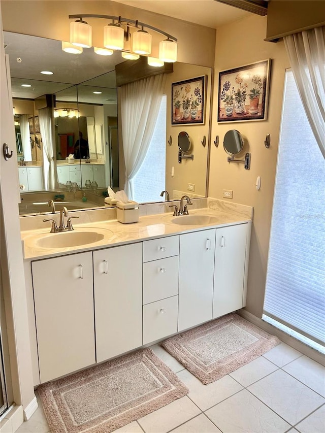 bathroom with double vanity and tile patterned flooring