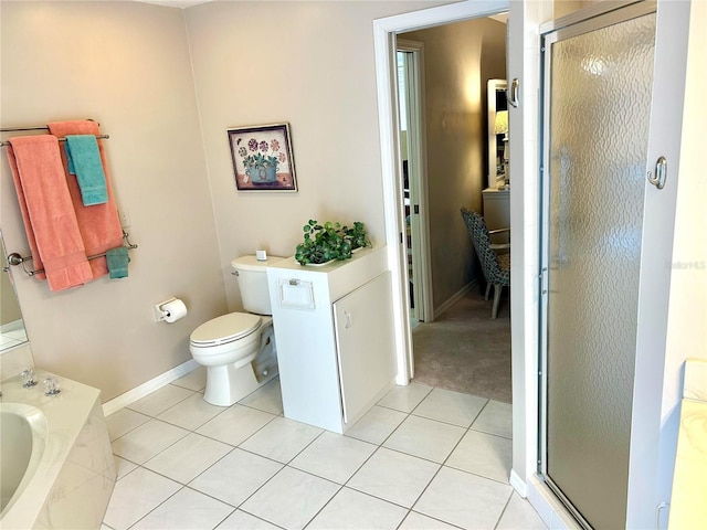 full bathroom featuring a stall shower, tile patterned flooring, a garden tub, toilet, and baseboards