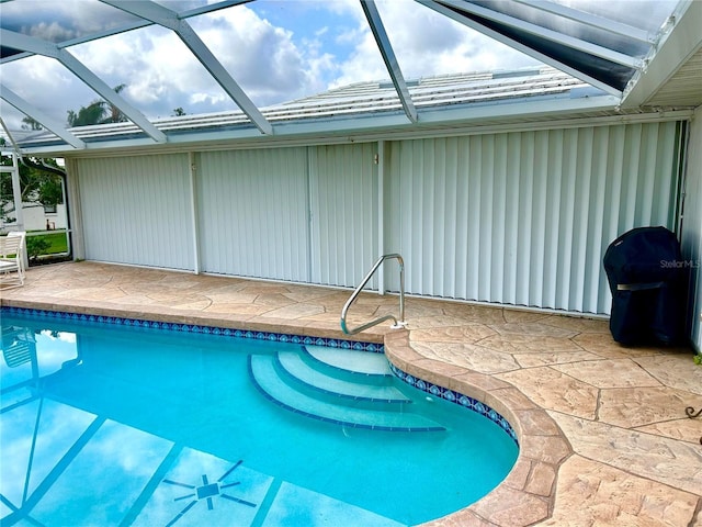 swimming pool with a patio area, a lanai, and grilling area