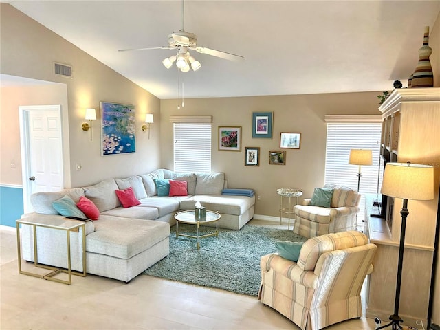 living room featuring ceiling fan, lofted ceiling, and baseboards