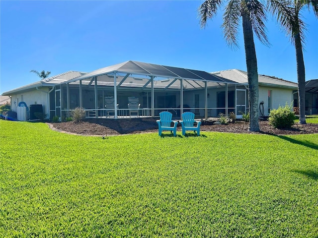 back of house with a lawn, stucco siding, and a lanai