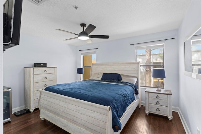 bedroom with ceiling fan, a textured ceiling, baseboards, and wood finished floors