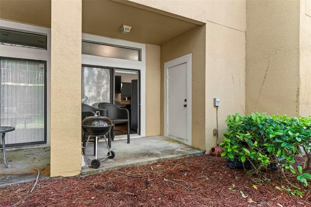 doorway to property with stucco siding