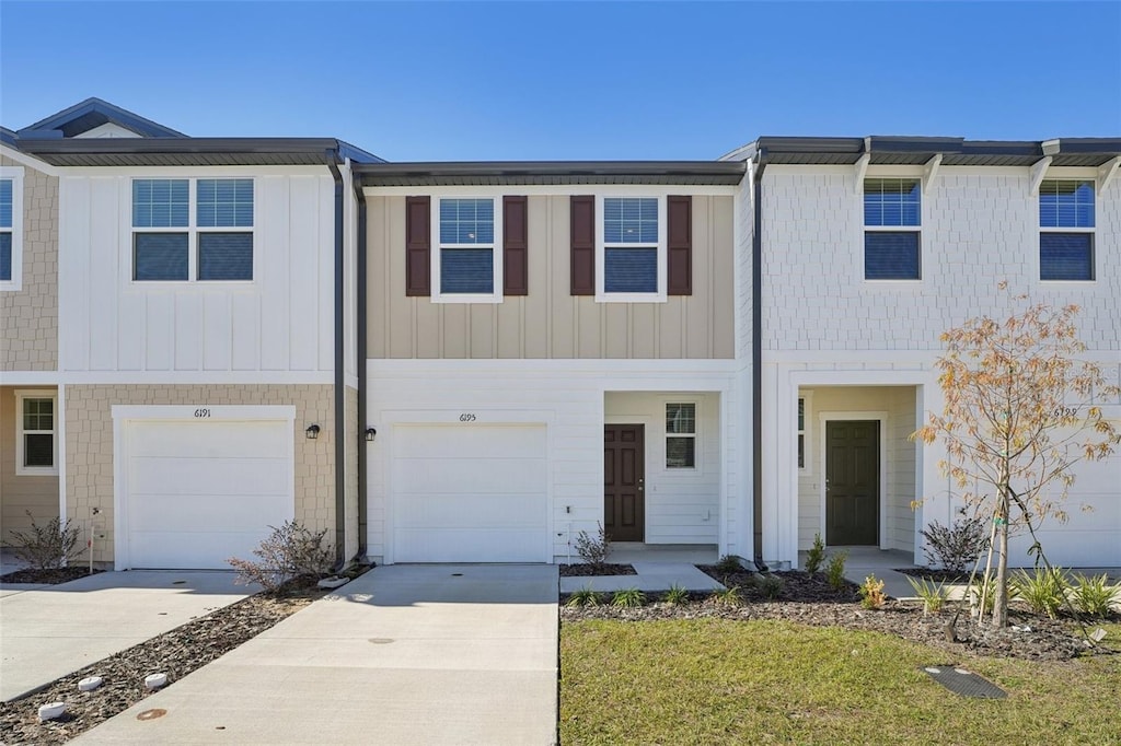 view of property with a garage and driveway