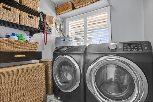 washroom with separate washer and dryer, laundry area, and water heater