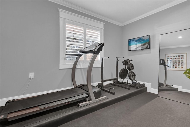 workout area featuring baseboards and ornamental molding