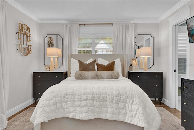 bedroom featuring crown molding, wood finished floors, and baseboards