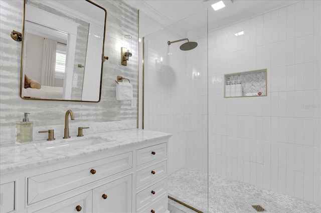 full bath with vanity, crown molding, and walk in shower