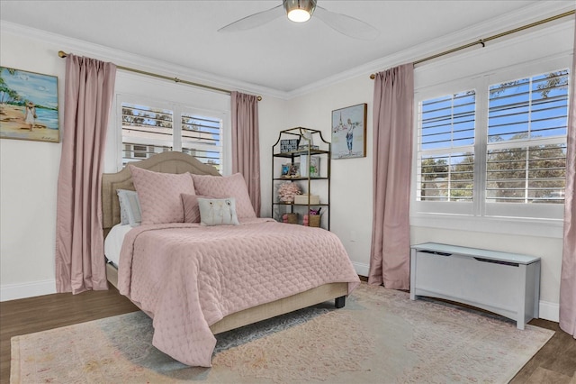 bedroom featuring radiator, multiple windows, wood finished floors, and ornamental molding