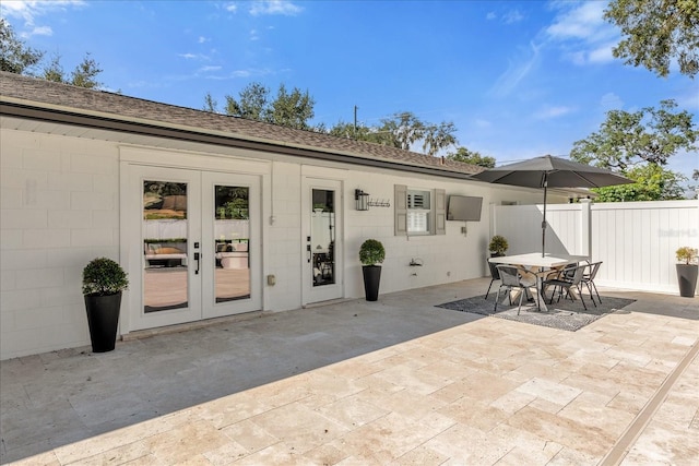 exterior space featuring outdoor dining space, french doors, and fence