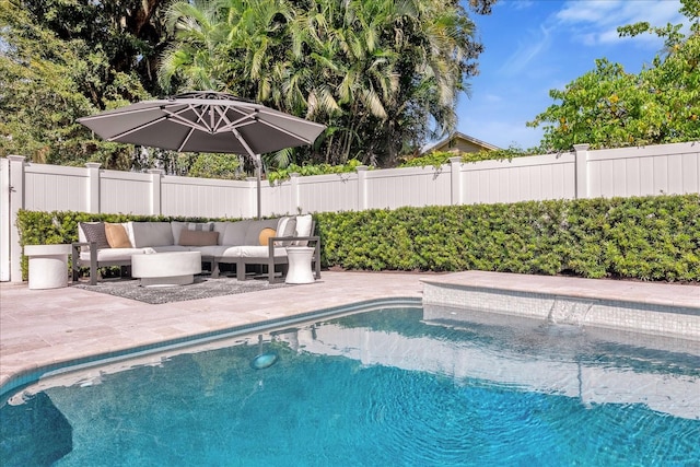 view of swimming pool featuring a patio, a fenced backyard, a fenced in pool, and an outdoor hangout area