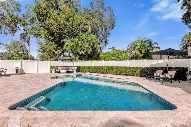 view of pool with an outdoor living space, a fenced in pool, a patio, and a fenced backyard