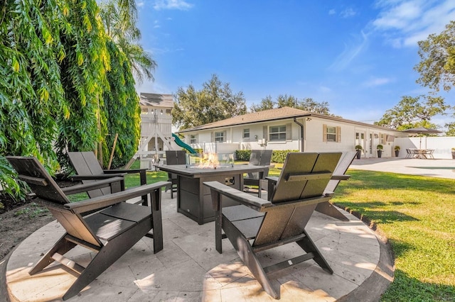 view of patio featuring a fire pit and a playground