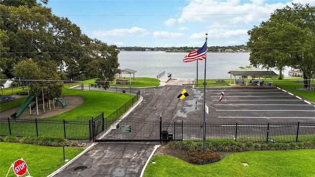 property view of water with a gate, a gazebo, and fence