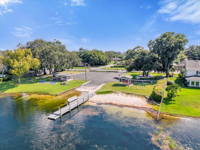 exterior space featuring a water view, a lawn, and fence