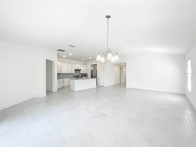 unfurnished living room featuring recessed lighting, visible vents, and a notable chandelier