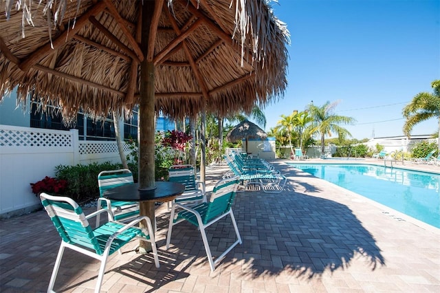 community pool featuring a gazebo, a patio, and fence