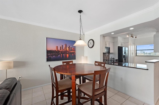 dining area featuring light tile patterned floors, baseboards, and ornamental molding