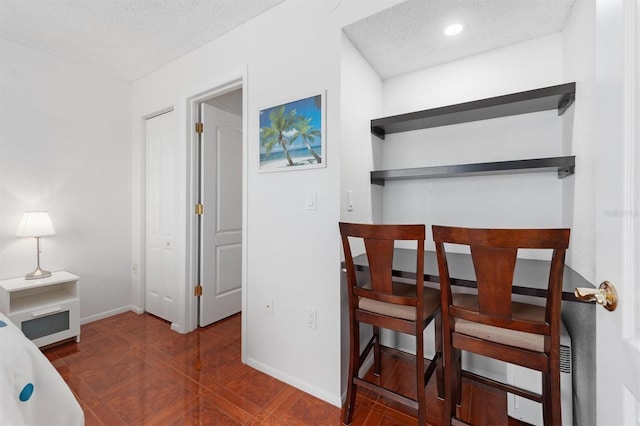 bedroom with recessed lighting, a textured ceiling, and baseboards