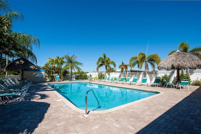 community pool featuring a patio area and fence