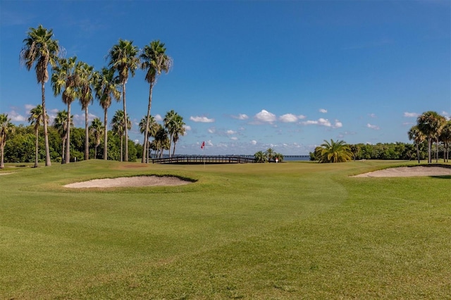 view of community featuring a yard and golf course view