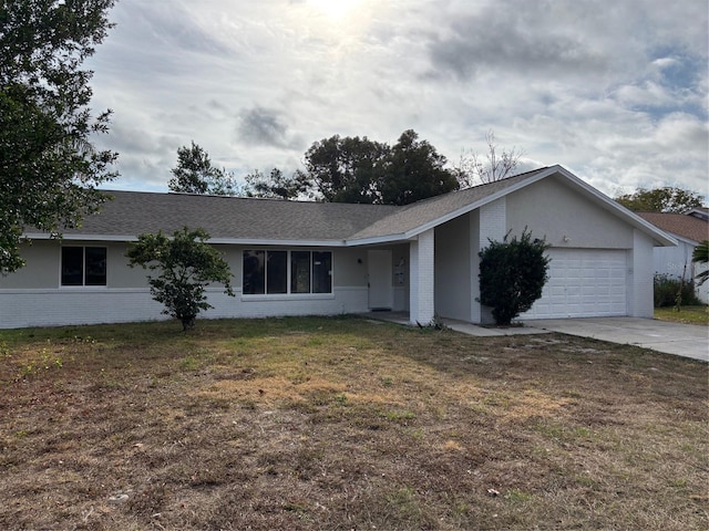 single story home featuring brick siding, roof with shingles, an attached garage, driveway, and a front lawn