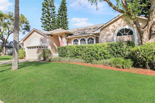 ranch-style house with an attached garage, a front yard, concrete driveway, and stucco siding