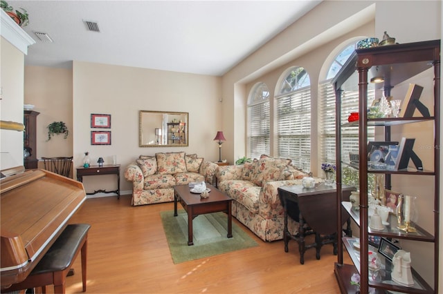 living room featuring visible vents and wood finished floors