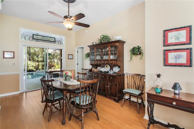 dining space featuring light wood-type flooring, ceiling fan, and baseboards