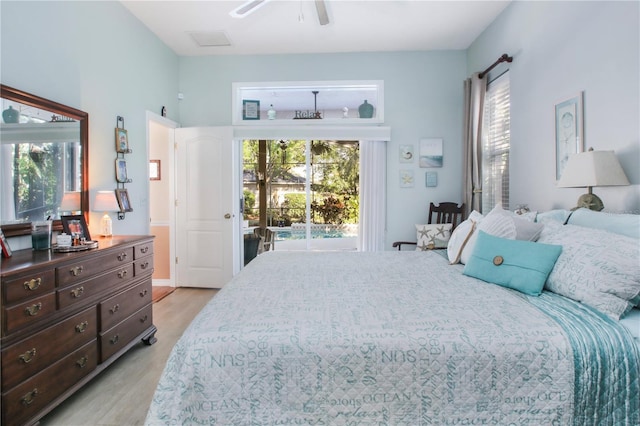 bedroom with access to exterior, multiple windows, ceiling fan, and light wood finished floors