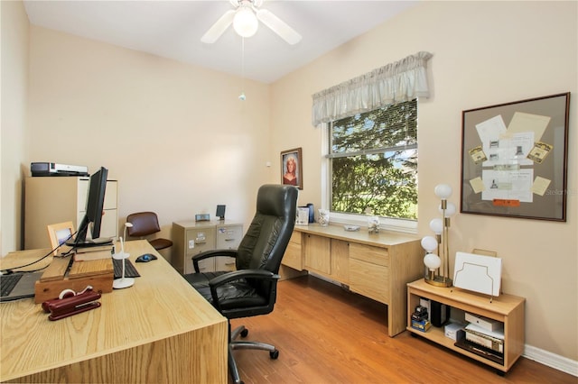 office featuring wood finished floors, a ceiling fan, and baseboards