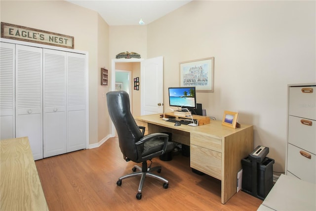 office area featuring light wood finished floors and baseboards