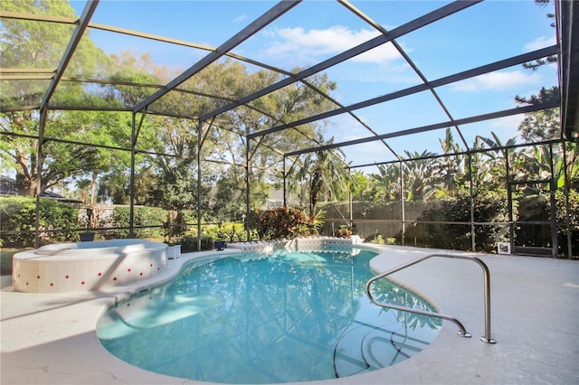 outdoor pool with glass enclosure and a patio