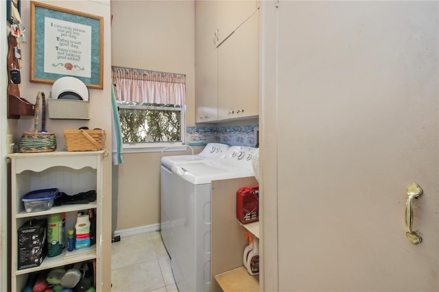 laundry room featuring cabinet space, washer and clothes dryer, baseboards, and tile patterned floors