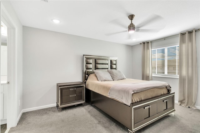 bedroom featuring baseboards, ceiling fan, and light colored carpet