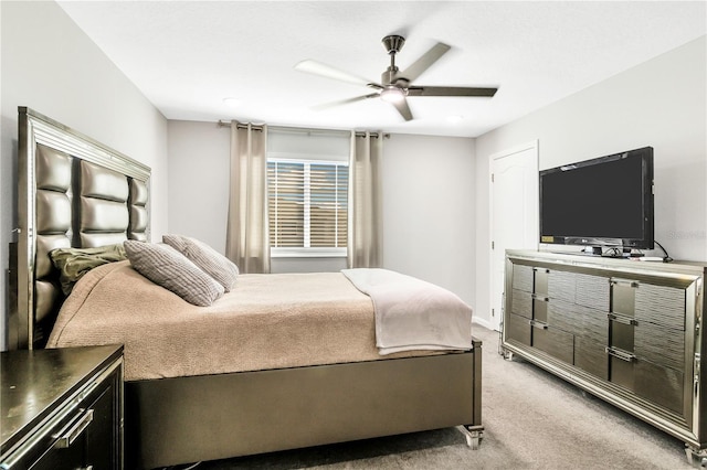 bedroom with a ceiling fan and light colored carpet