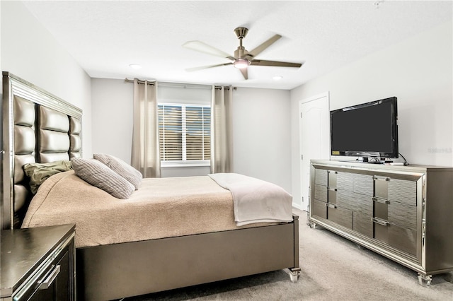 bedroom with ceiling fan and light colored carpet