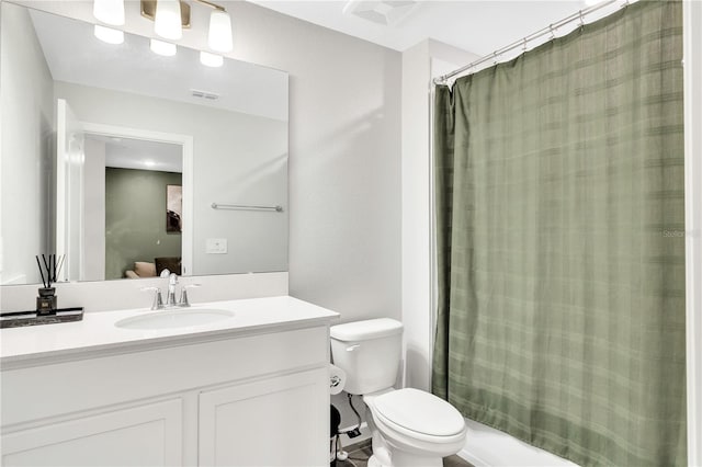 bathroom featuring toilet, a shower with curtain, visible vents, and vanity