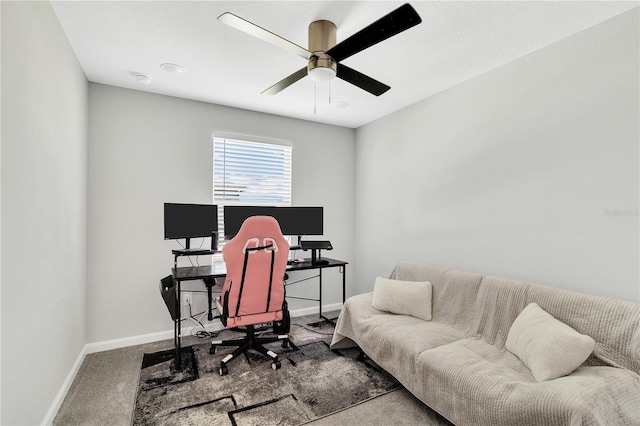 office featuring carpet, baseboards, and a ceiling fan