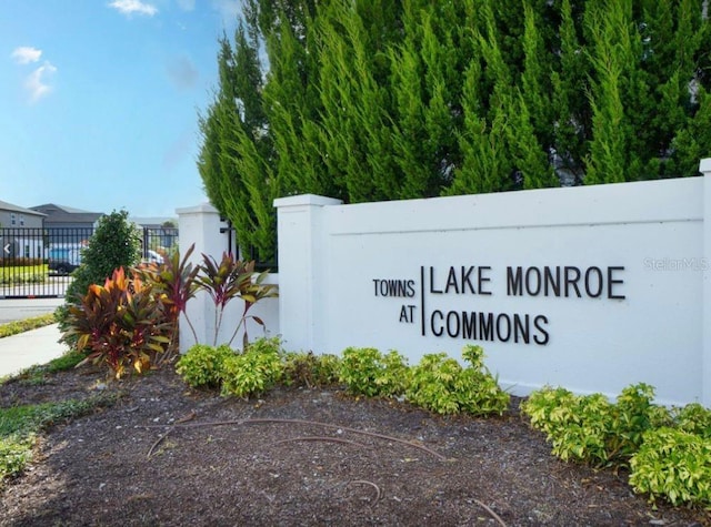 community sign featuring fence