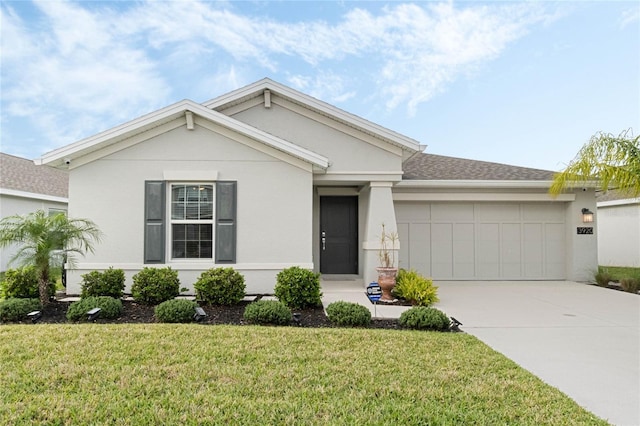 ranch-style home featuring concrete driveway, a front lawn, an attached garage, and stucco siding