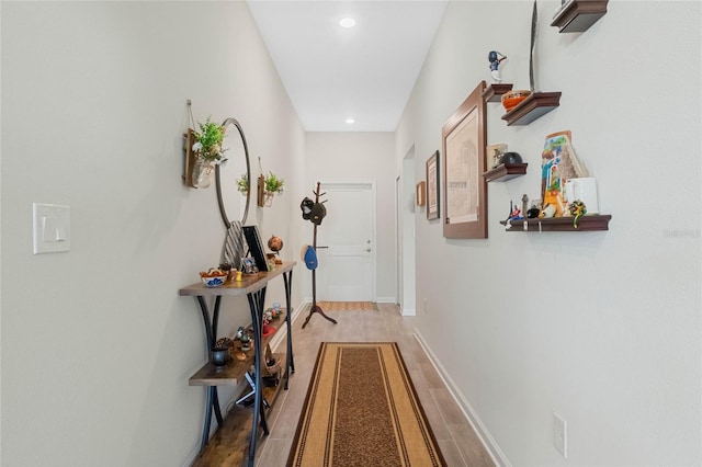 entryway featuring recessed lighting, baseboards, and light wood finished floors