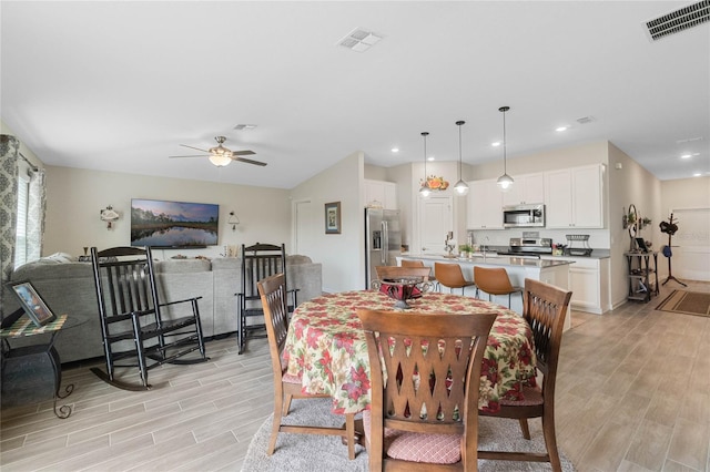 dining room featuring wood finish floors, visible vents, ceiling fan, and recessed lighting